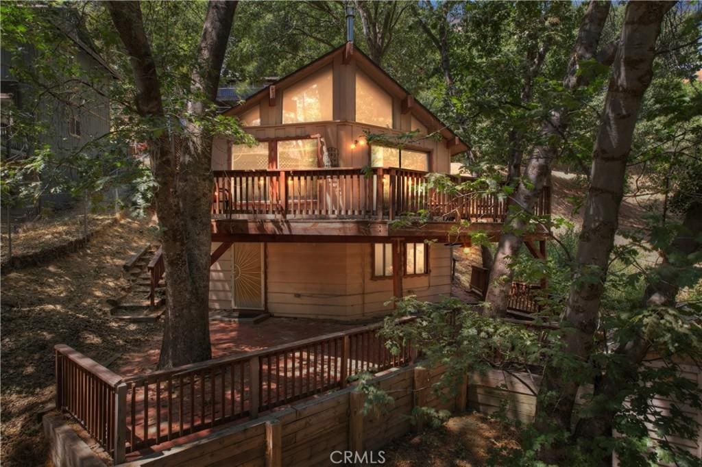 back of house featuring a wooden deck