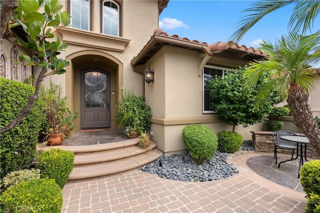 property entrance featuring a patio area