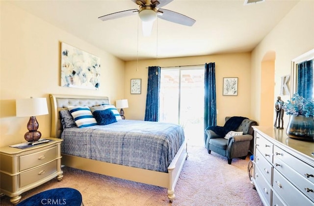 bedroom with ceiling fan and light carpet