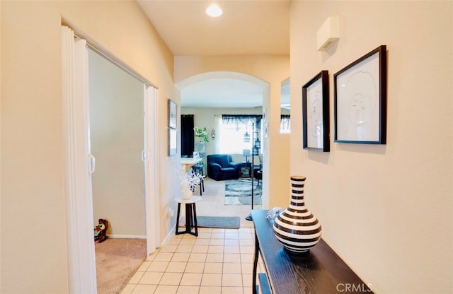 hallway with light colored carpet