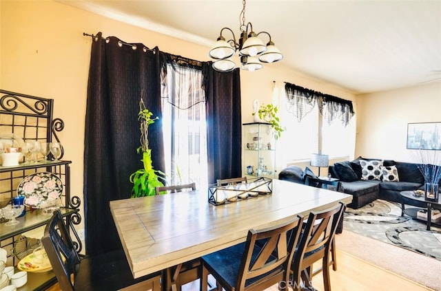 dining space with a chandelier and hardwood / wood-style flooring