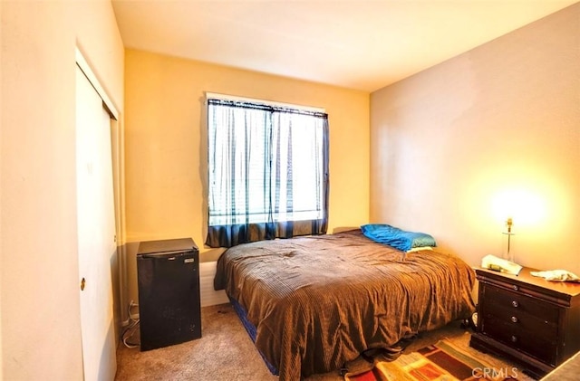 bedroom featuring light carpet