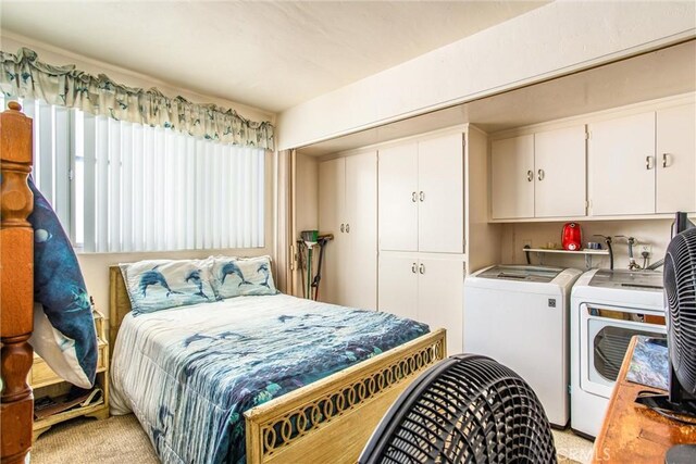 carpeted bedroom featuring washer and clothes dryer