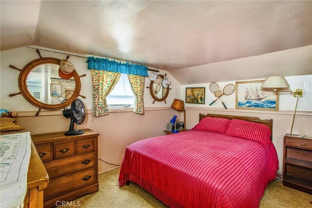 bedroom featuring light colored carpet and lofted ceiling