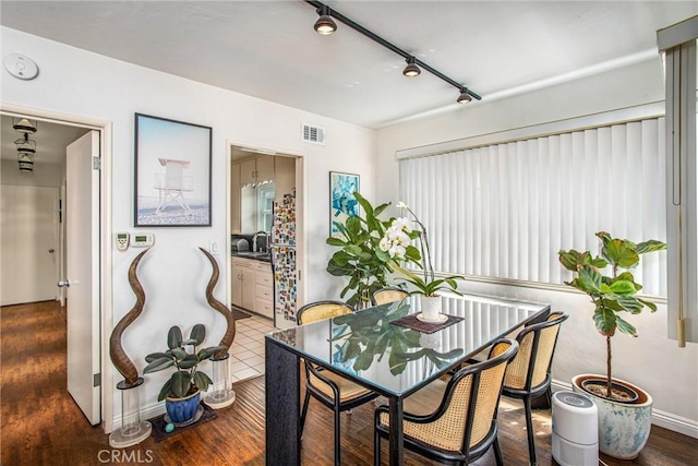 dining room with wood-type flooring