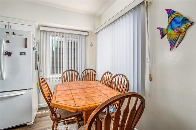 dining area with hardwood / wood-style floors