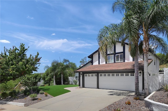 view of front of house featuring a garage and a front lawn