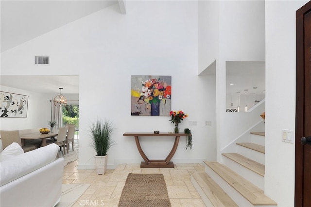 living room with beamed ceiling and high vaulted ceiling