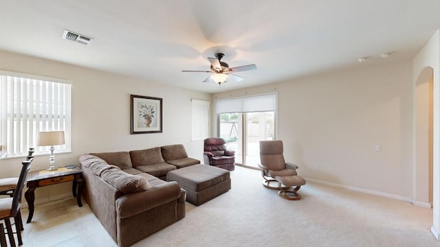 carpeted living room with ceiling fan