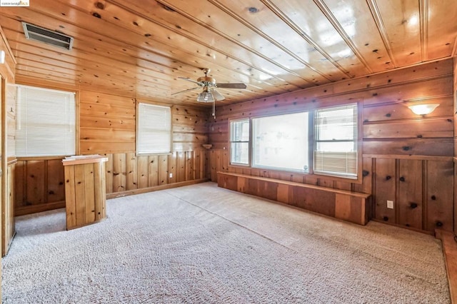 bonus room with ceiling fan, wood walls, light colored carpet, and wood ceiling