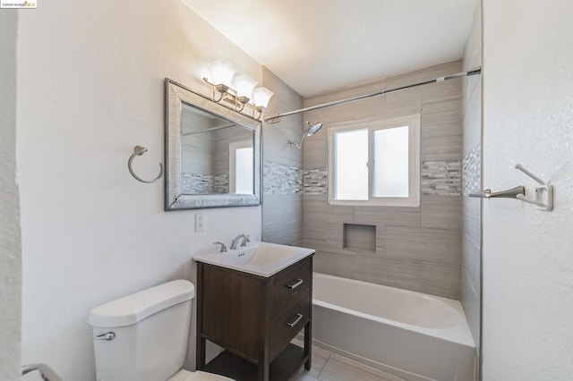 full bathroom featuring tile patterned flooring, vanity, toilet, and tiled shower / bath