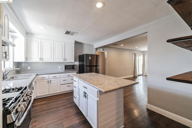 kitchen with white cabinets, stainless steel appliances, dark wood-type flooring, and sink