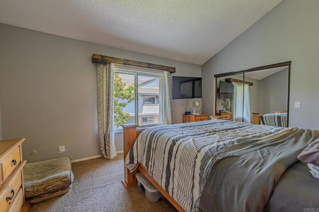 bedroom featuring a textured ceiling, a closet, carpet, and lofted ceiling