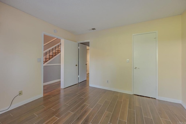 unfurnished room with dark hardwood / wood-style floors