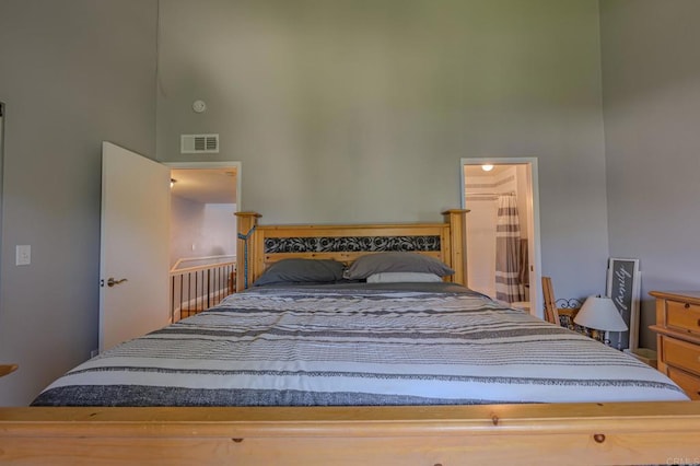 bedroom featuring a towering ceiling