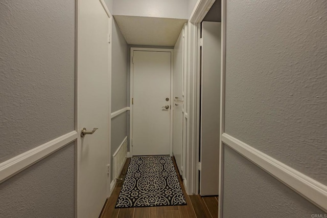 hallway with dark hardwood / wood-style floors