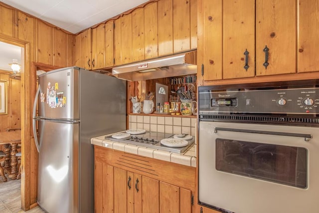 kitchen featuring tile countertops and appliances with stainless steel finishes