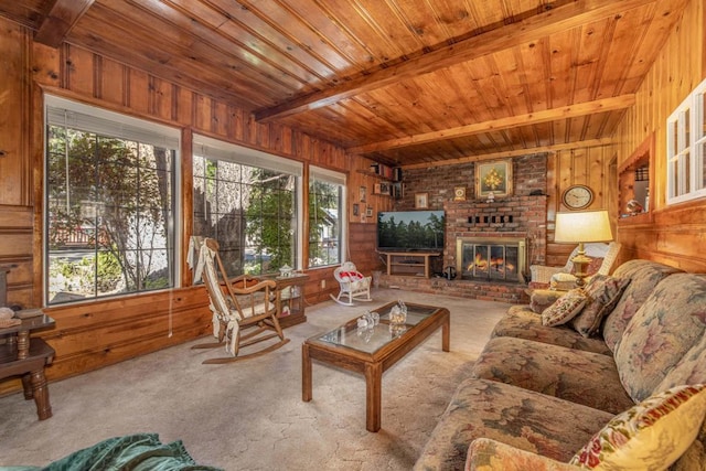 carpeted living room with beam ceiling, wooden walls, a fireplace, and wood ceiling