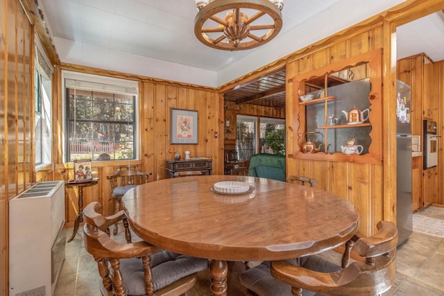 dining room featuring wooden walls