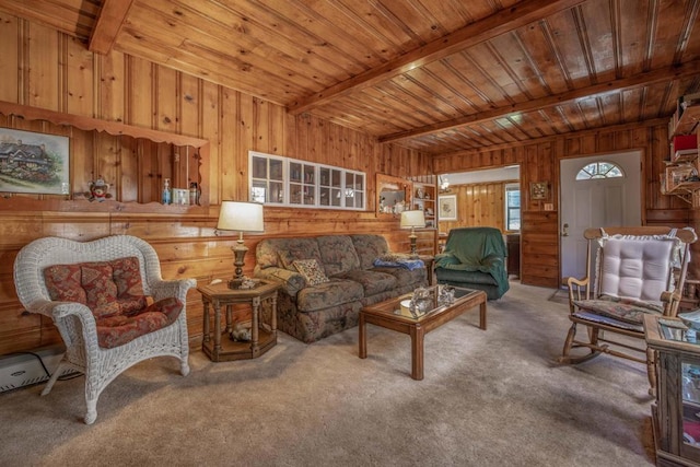 living room featuring beamed ceiling, carpet flooring, wood walls, and wooden ceiling