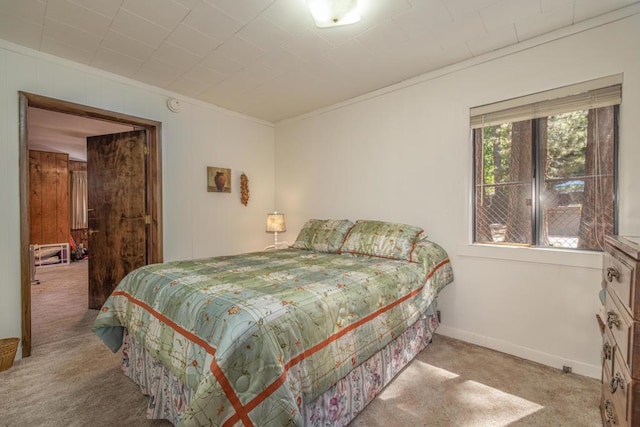 bedroom featuring crown molding and light carpet