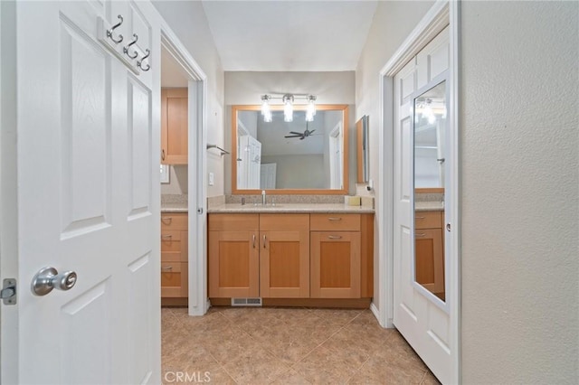 bathroom with vanity and ceiling fan