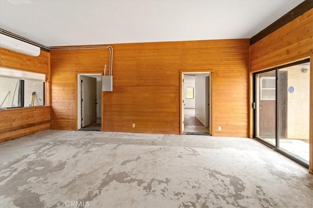 spare room featuring wood walls