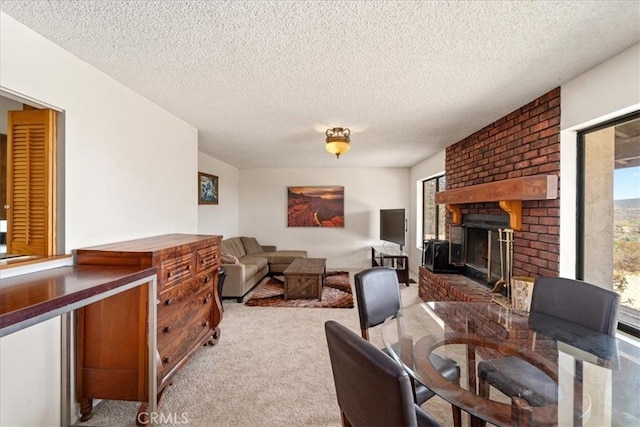 carpeted living room featuring a fireplace and a textured ceiling