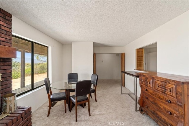 carpeted dining area featuring a textured ceiling