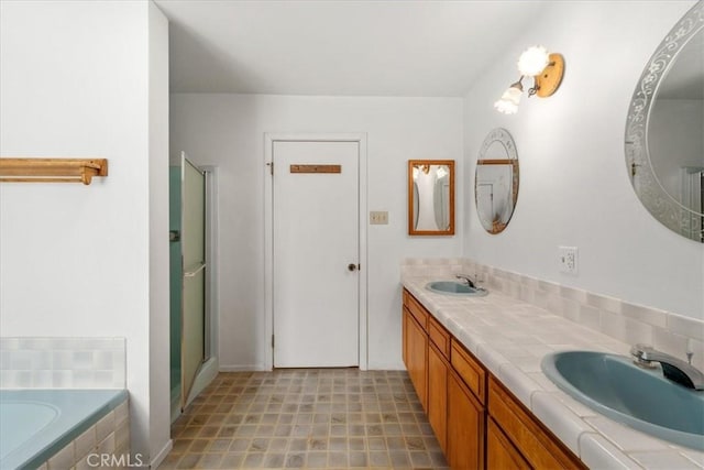 bathroom with a relaxing tiled tub and vanity