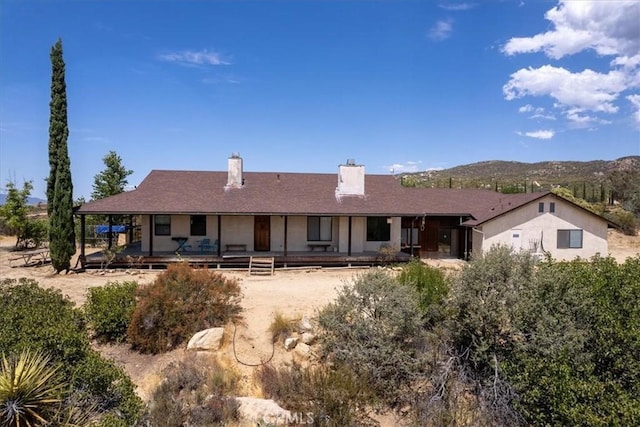 rear view of house featuring a mountain view