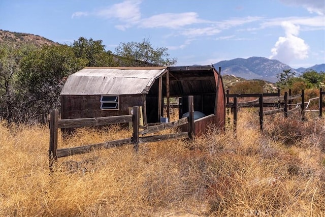 view of outdoor structure featuring a mountain view and a rural view