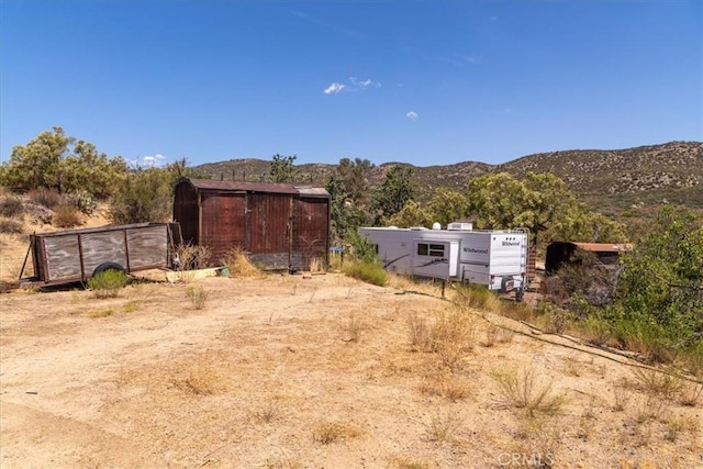 view of yard with a mountain view and an outdoor structure