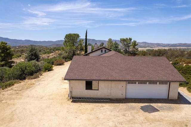 exterior space with a mountain view and a garage