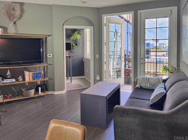living area with baseboards and wood tiled floor