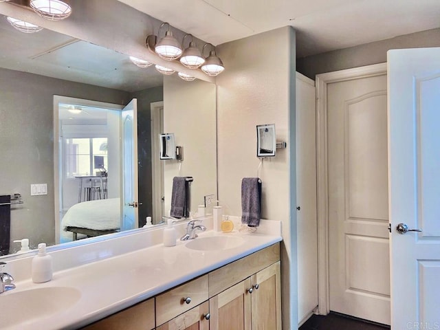 bathroom with ensuite bath, a sink, and double vanity