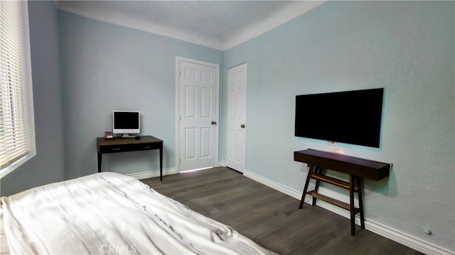 bedroom with dark wood-type flooring