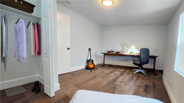 office area with vaulted ceiling and hardwood / wood-style floors