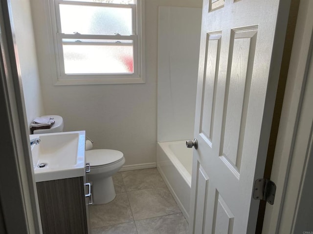 bathroom with tile patterned flooring, vanity, toilet, and a washtub