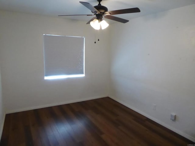 spare room with dark hardwood / wood-style floors and ceiling fan