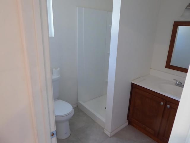 bathroom with vanity, toilet, and walk in shower