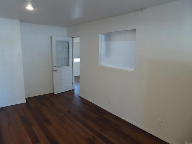 spare room featuring dark hardwood / wood-style flooring