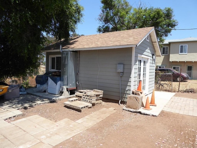 rear view of property with an outbuilding