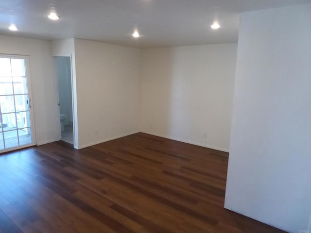 empty room with dark wood-type flooring