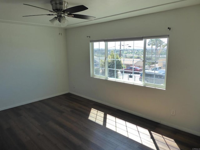 unfurnished room with ceiling fan and dark hardwood / wood-style flooring