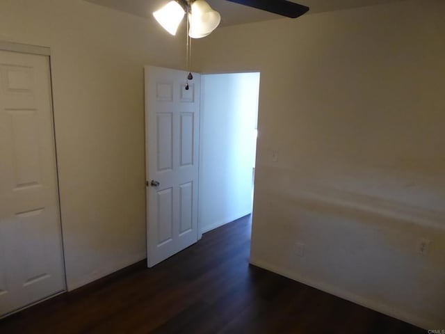 interior space featuring a closet, ceiling fan, and dark hardwood / wood-style flooring