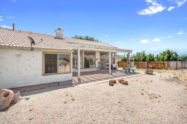 rear view of house with a patio and a pergola