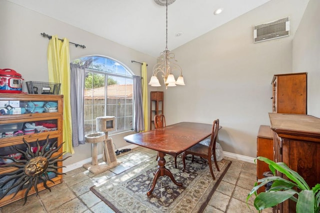 dining area featuring lofted ceiling and a chandelier