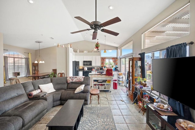 living room with lofted ceiling and ceiling fan with notable chandelier