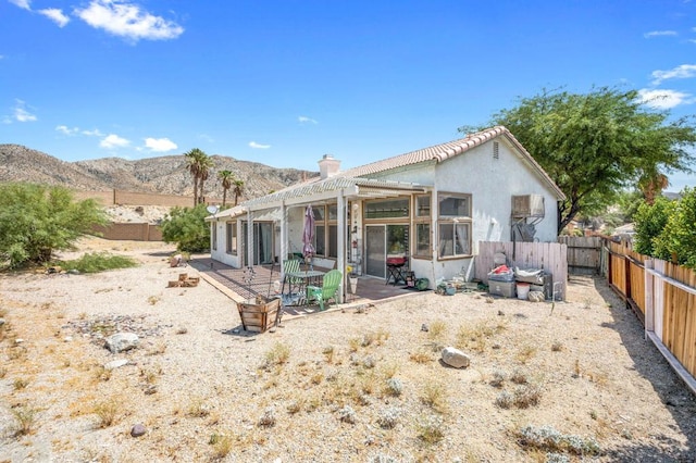 rear view of property with a patio and a mountain view